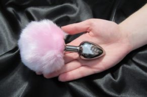 A sexy pink rabbit’s tail as a steel anal plug…